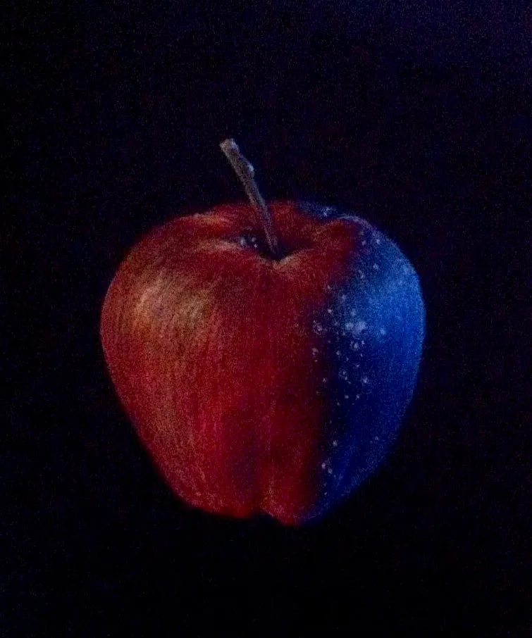 Red apple drawn on a black background with one half shaded in blue light with sparkles.
