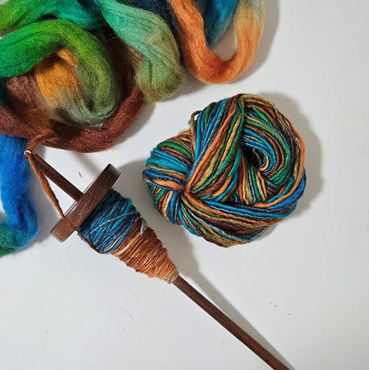 Colorful yarn on a drop spindle